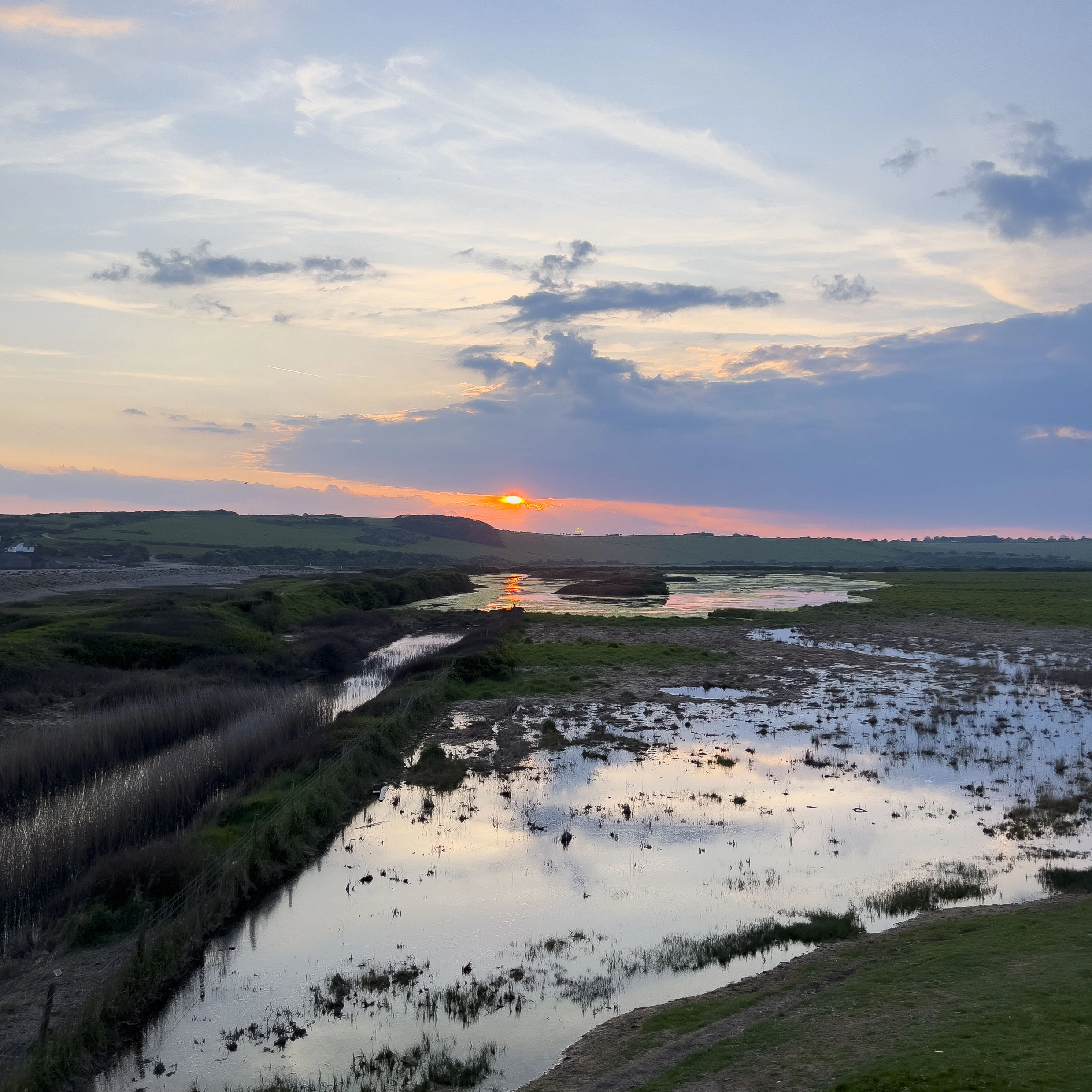 The Sun setting over Cuckmere and the Seven Sisters